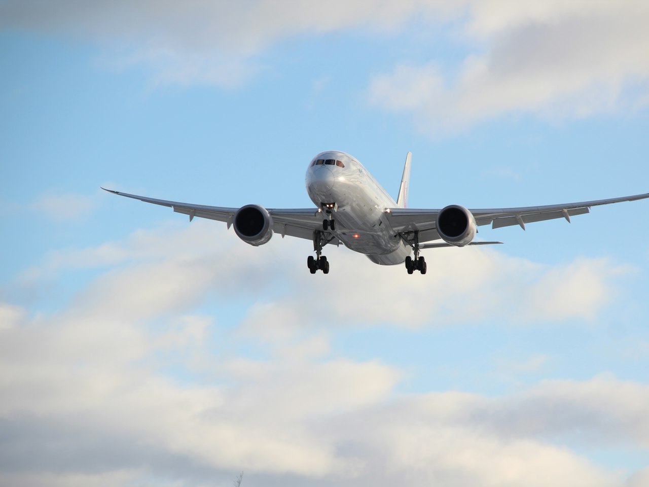A passenger aircraft in flight against a clear sky