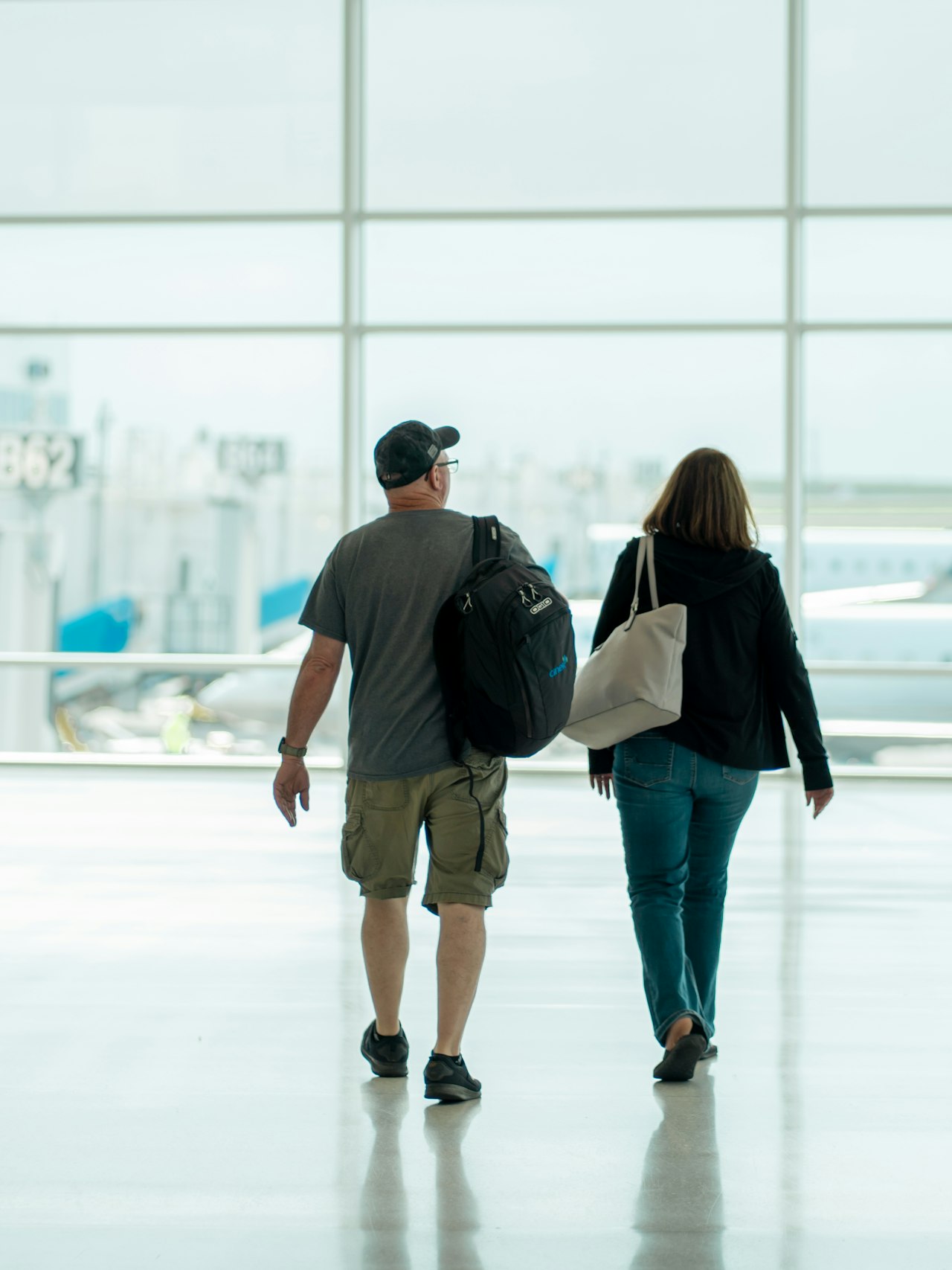 Travellers making their way through an airport terminal