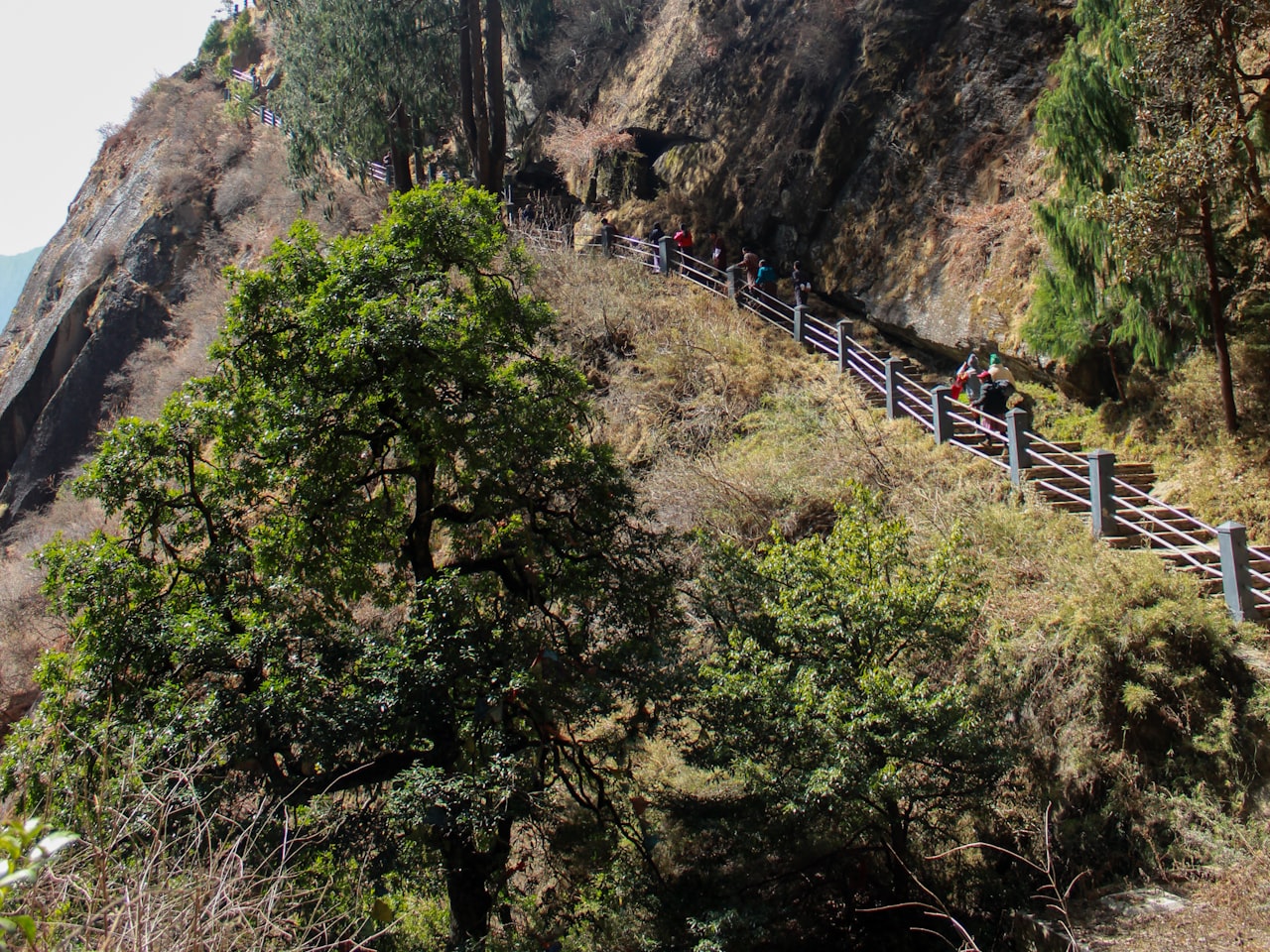 Travellers climbing a mountain path in Bhutan
