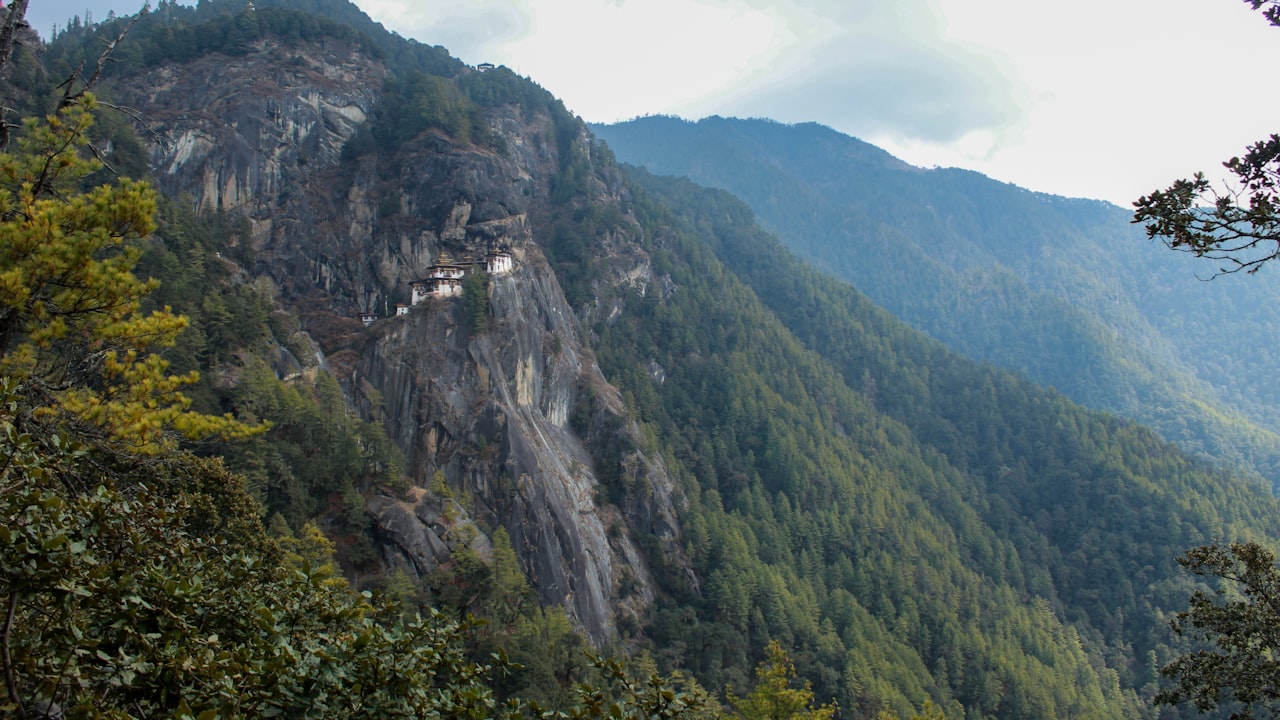 Forested mountain ridges receding into mist in Bhutan