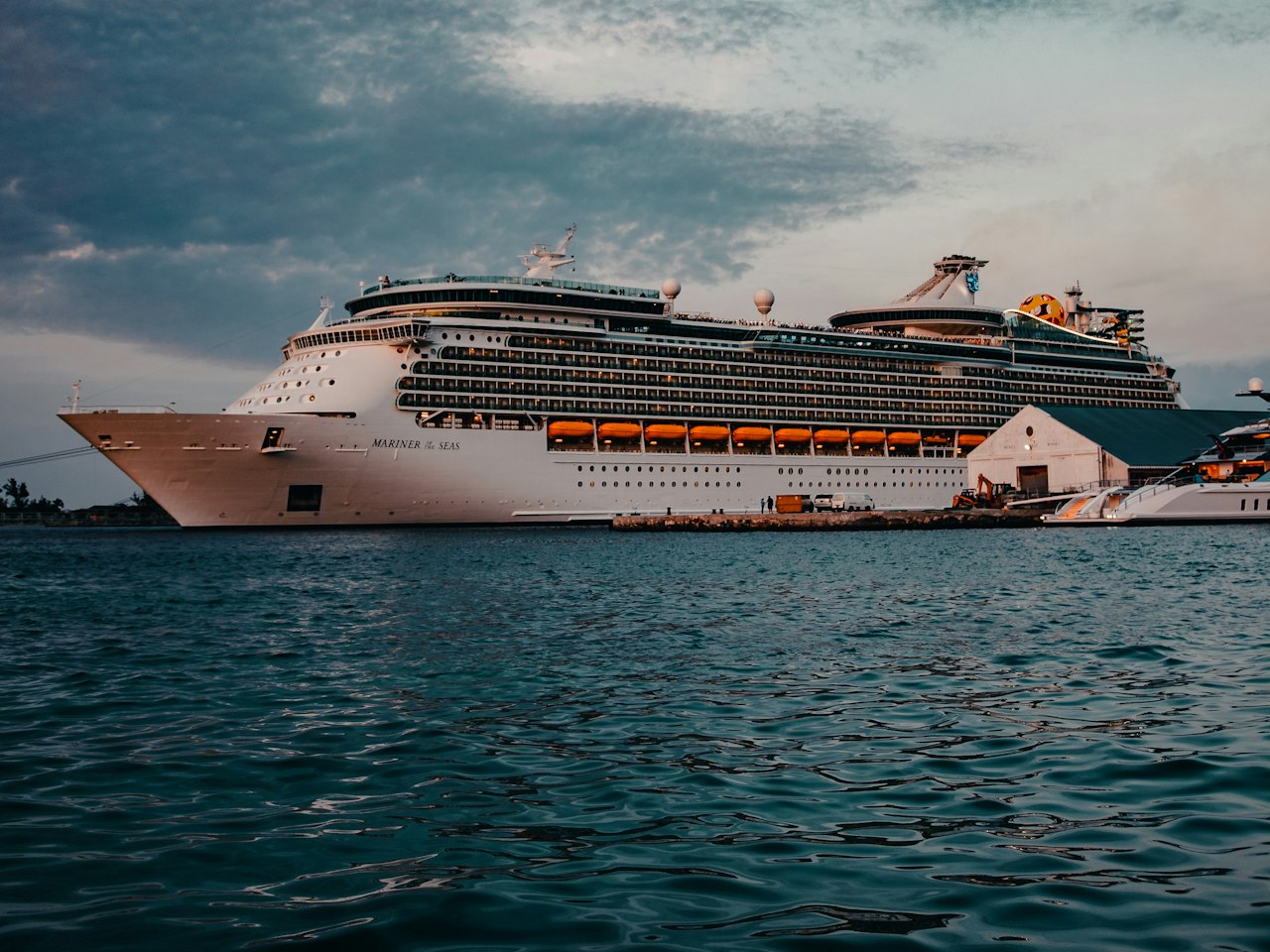 A cruise ship at sea under a bright sky