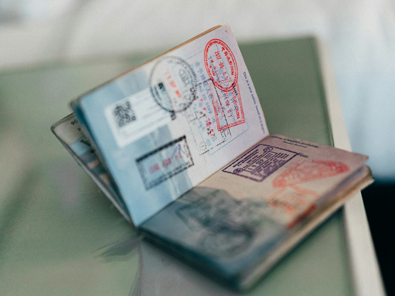 An open passport showing entry and exit stamps